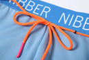 a close up of a blue and orange swimsuit with a name on it