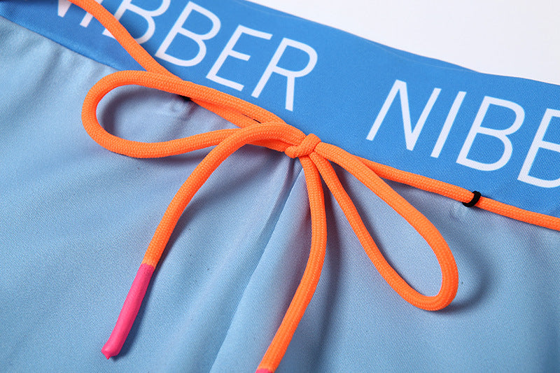 a close up of a blue and orange swimsuit with a name on it